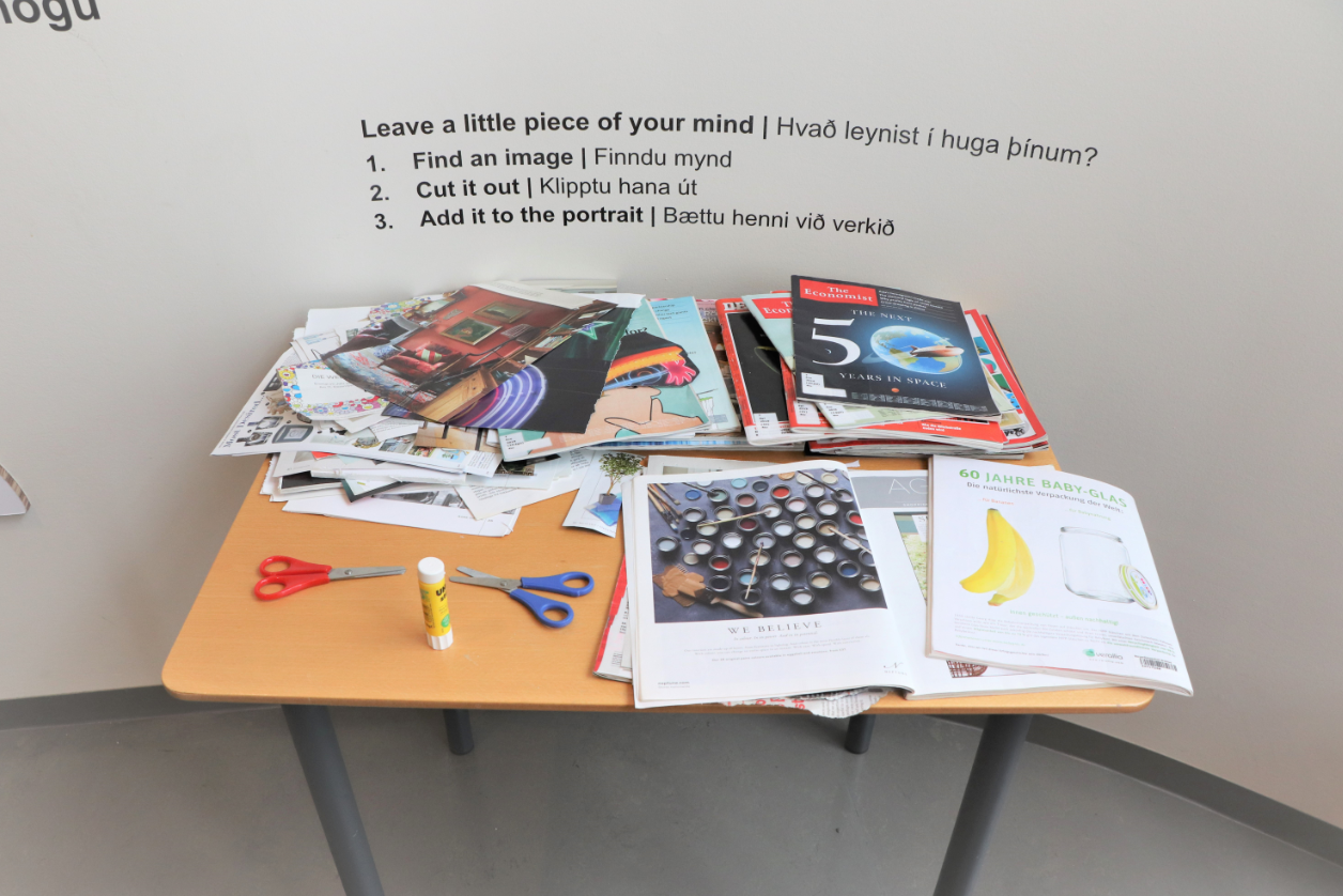 newspapers and magazines on table with scissors and glue