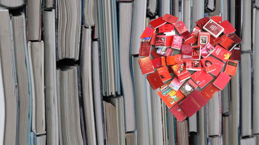 books creating the shape of a red heart