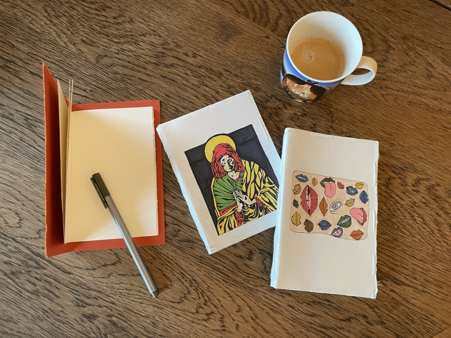 Notebooks made by and with K.óla Homemade notebooks on a wooden table